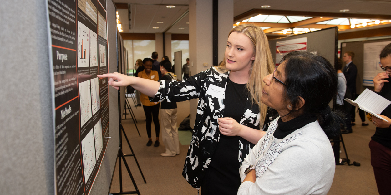 Two students working at the board at SIUE