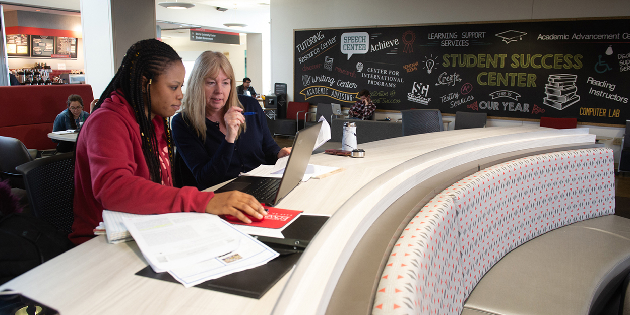 Two women talking in the Student Success Center at SIUE.