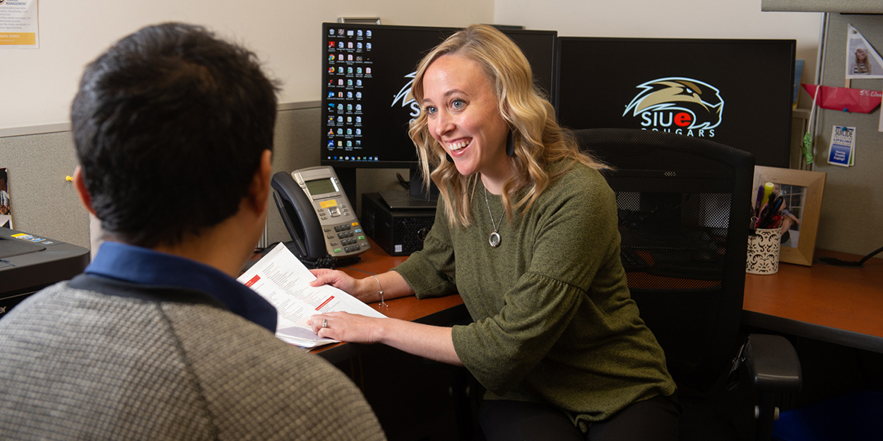 Career Development Center employee working with a student. 