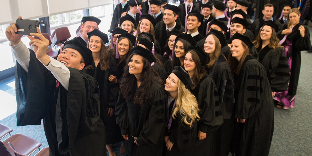 Dental Medicine students taking a selfie when getting there DMD.