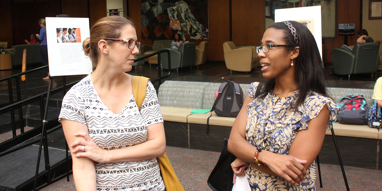 Two faculty members meet in the Goshen Lounge at the Morris University Center.