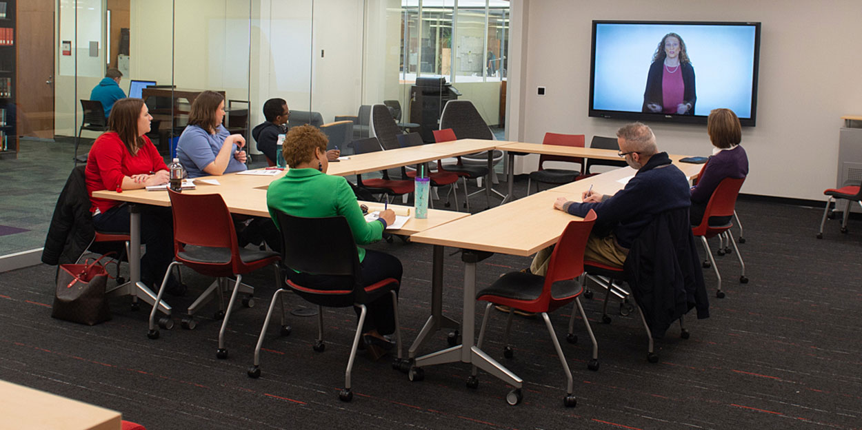 Professors meeting in a conference room. 