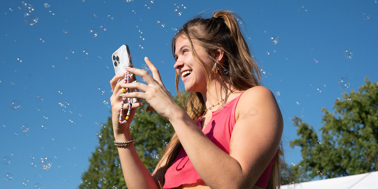 A student taking pictures during homecoming.