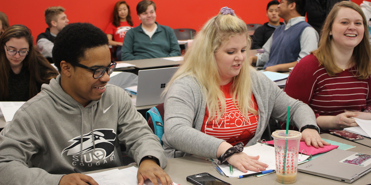 SIUE Students working in a classroom.