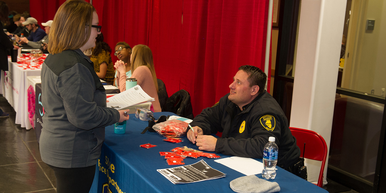 SIUE police officer meeting with a student at the Morris University Center.