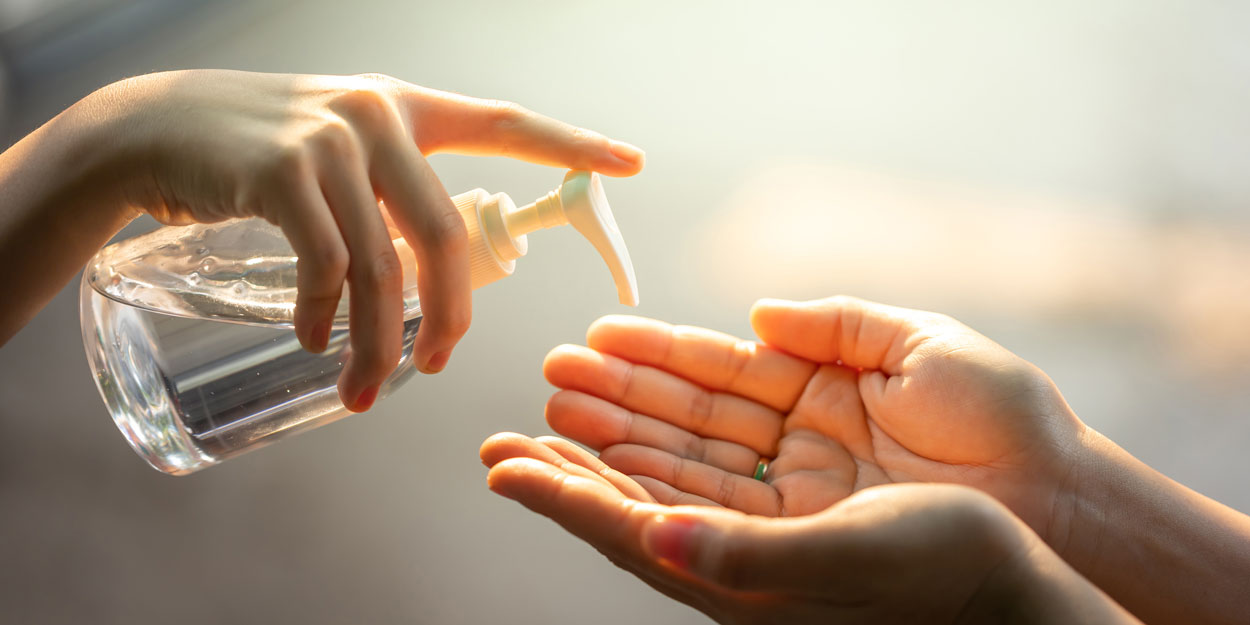 A hand using hand sanitizer