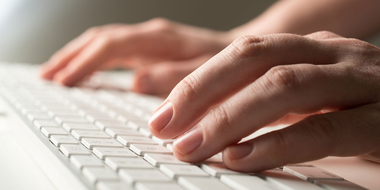 Hands typing on a keyboard