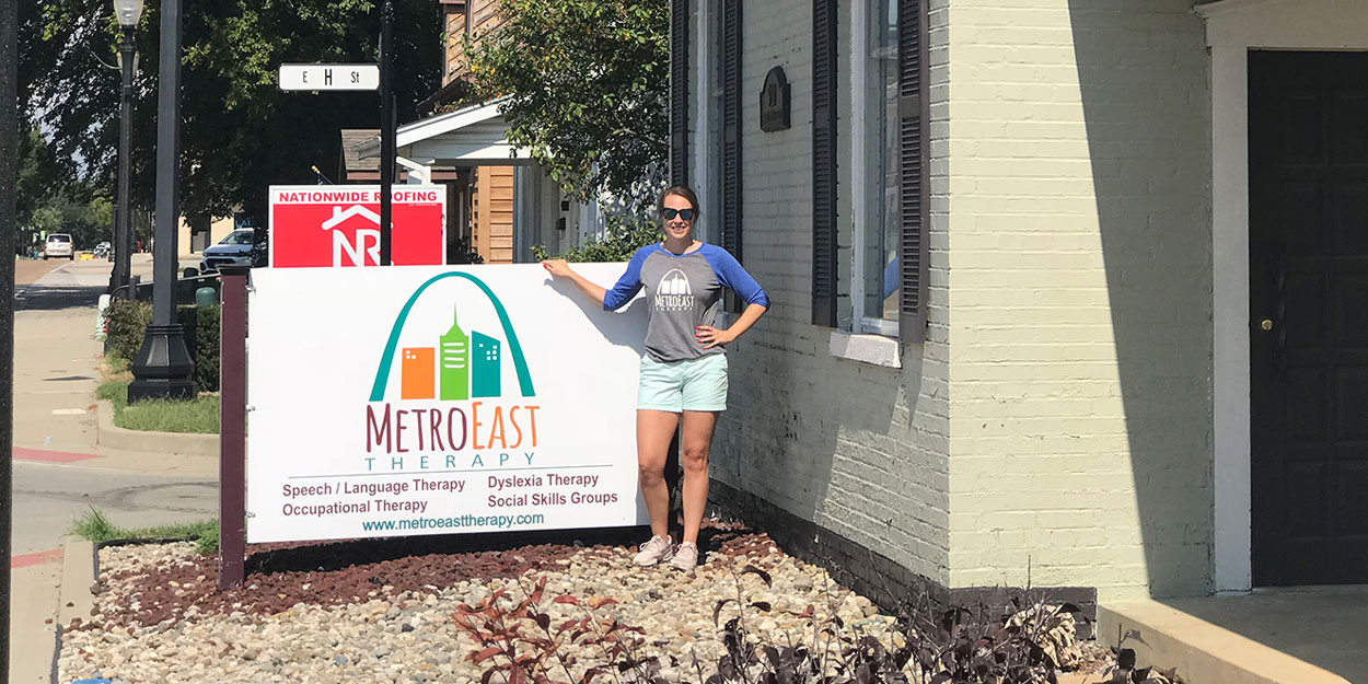 Woman standing in front of Metro East Therapy.