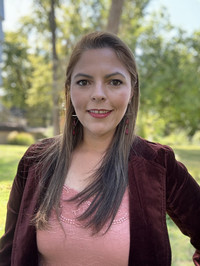 Portrait of Adriana Martinez outside wearing a blazer