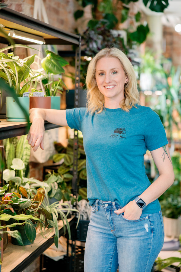 Photo of Jamie Shrum standing by her plants