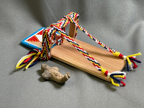 Artifacts of a baby figure and cradle on table