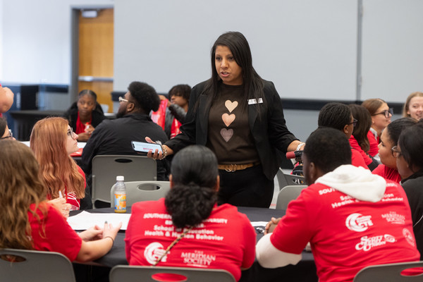 Teacher talks to table of students