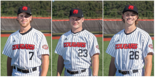 Three baseball players in uniform facing the camera