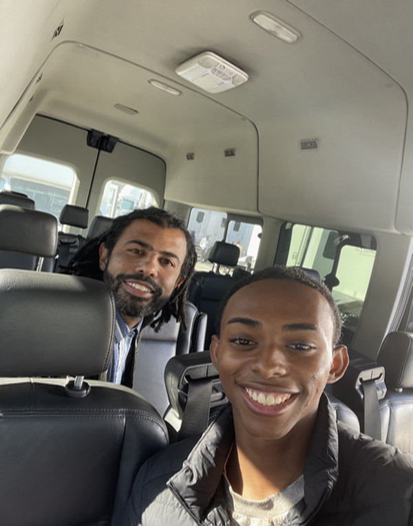 Two actors in a van posing for photo Daveed Diggs and Trey Perkins