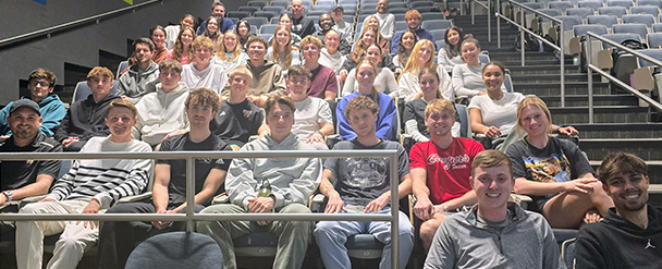 Members of the mens and womens soccer team in a lecture hall