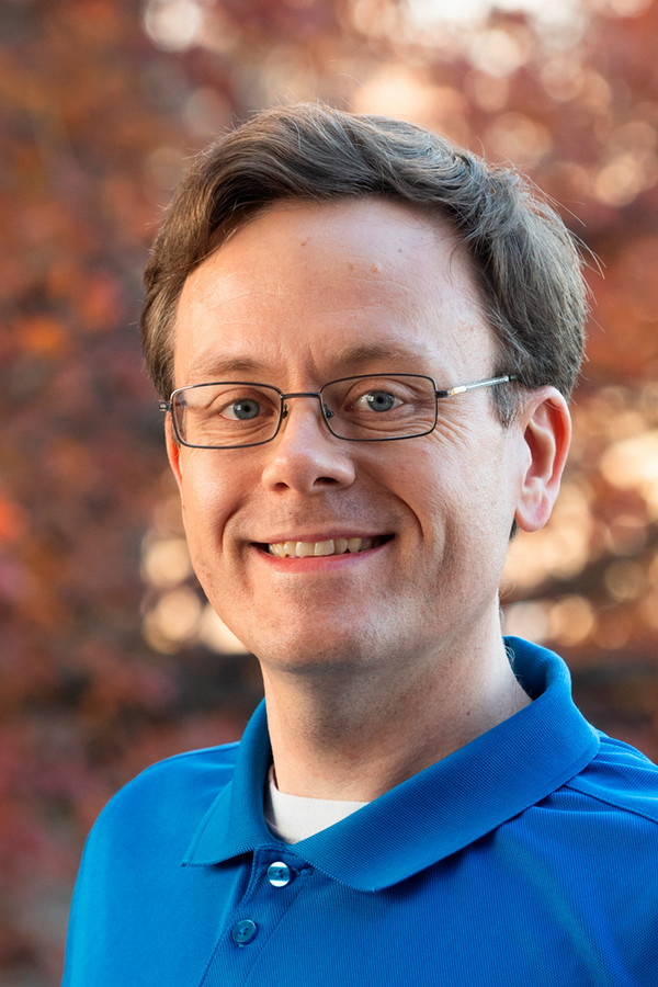 Portrait of Dr Alan Black in blue shirt