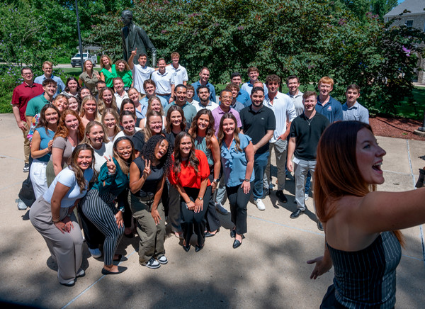 The class of dental students pose for a selfie