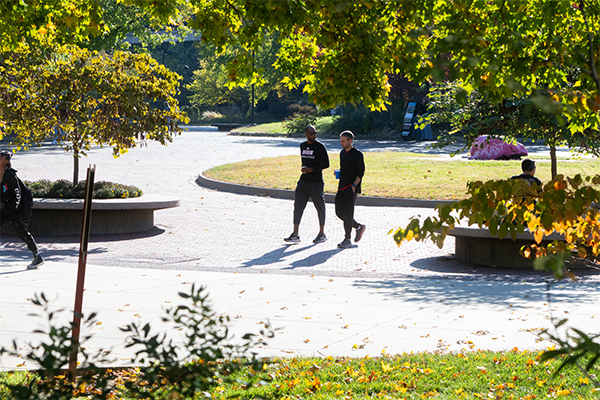 High angle image of two male students walking across Stratton Quad